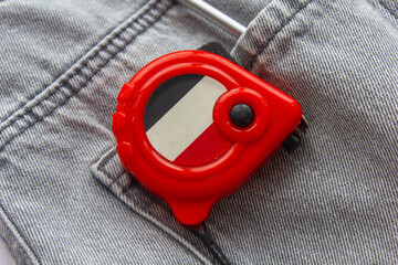 Naklejka premium tape measure, construction tools for repair, photo background, builder's day, jeans, repair, tape measure for measurements