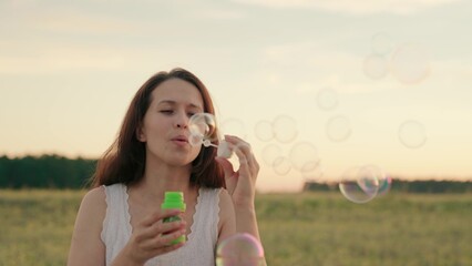 woman blowing soap bubbles park. festive mood. women outdoor recreation. happy woman vacation...