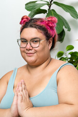 Woman meditating at home looking at camera