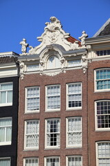 Prinsengracht Canal House Facade with Sculpted Roof Decoration in Amsterdam, Netherlands