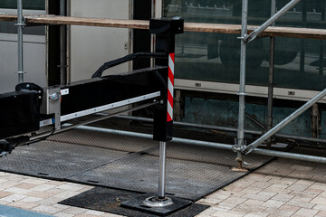 Construction equipment is positioned on a city street, surrounded by scaffolding. The setup...