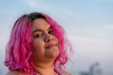 Woman with pink hair  against the blue sky