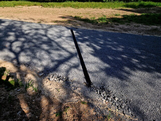 renovation of asphalt road in the mountains. The ditches are filled with stones to slow down the...