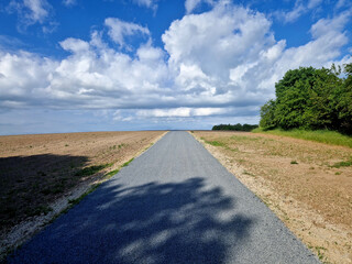 renovation of asphalt road in the mountains. The ditches are filled with stones to slow down the...