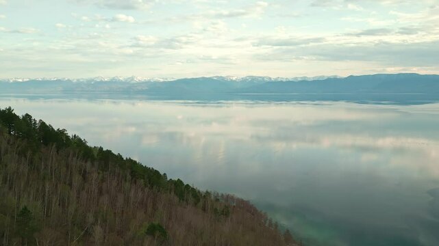 Spring landscape of Lake Baikal with a view of clear water and high rocky hills