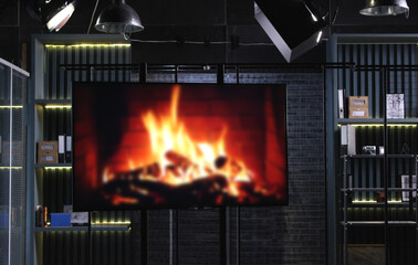 Studio Screen Monitor with Blurred Bonfire and Shelves with Thematic Items