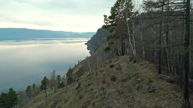 Spring landscape of Lake Baikal with a view of clear water and high rocky hills