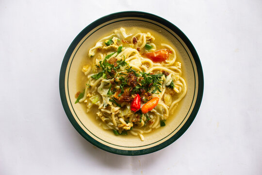 Mie godog Jawa or bakmi jawa or java noodle or Mie rebus or boiled noodles with spoon and fork. Indonesian traditional street food noodles from java, indonesia on white backgroud