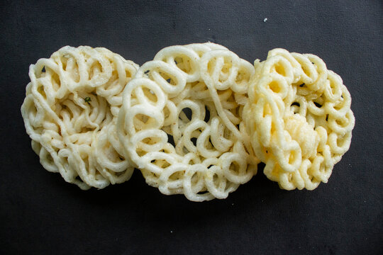 kerupuk or krupuk or crackers isolated on black background. kerupuk is snacks made from tapioca flour dough mixed with flavorings such as shrimp or fish. traditional snack from indonesia