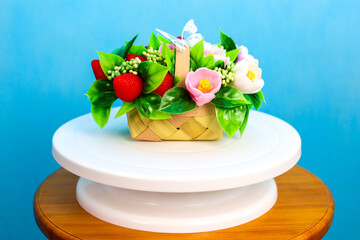Delicate Handmade Soap Flower Bouquet on a Soft Blue Background - Perfect for Gifts and Decor.