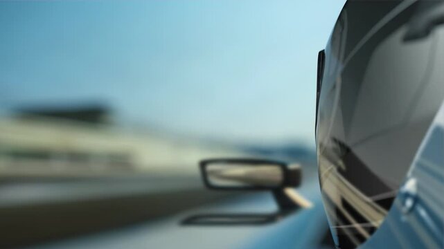 Fast racing video capturing a close-up of the driver helmet and track reflections as the car accelerates down the race circuit.