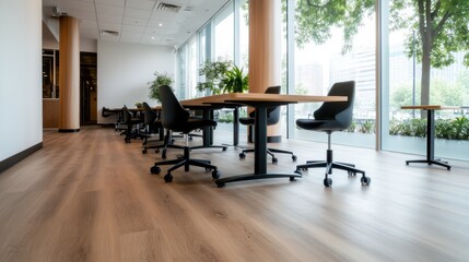 Fototapeta premium A contemporary office featuring large windows that allow natural light to illuminate the spacious area filled with sleek furniture, creating a productive professional atmosphere.