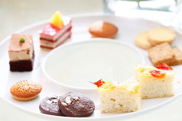 Assorted delicious desserts and cakes exquisitely arranged on table, close-up, festive celebration, buffet