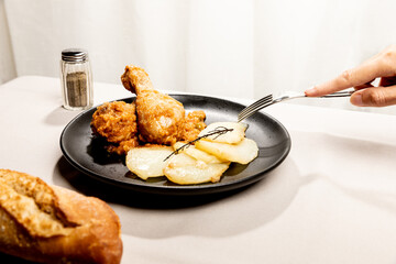 Baked chicken with vegetable sauce and sliced potatoes.