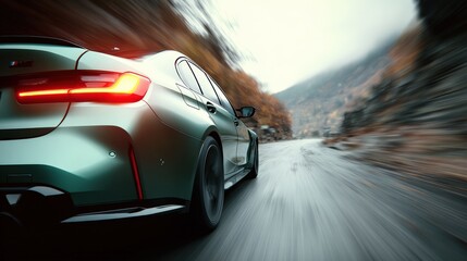 Modern sleek electric sedan driving fast on mountain road du daytime with motion blur