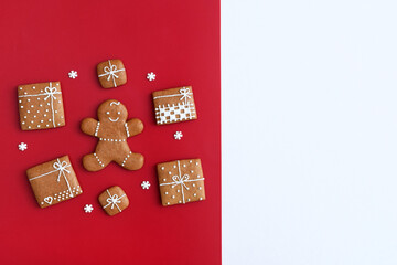 Decorated gingerbread cookies - gingerbread man and christmas presents with small sugar snowflakes, copy space for text