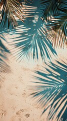 summer background of beach sand with shadows from palm leaves, top view