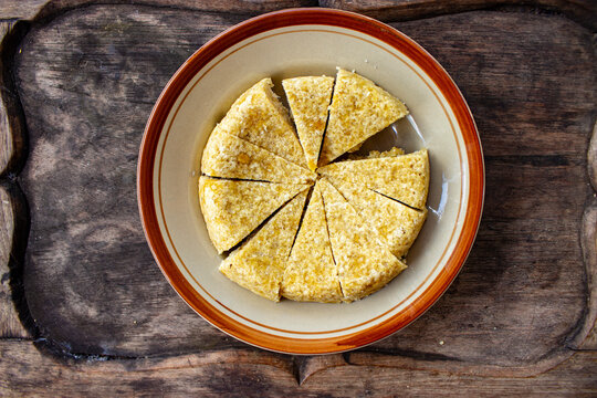 Krasikan is traditional food/ snack from java made glutinous rice, coconut milk, brown sugar, grated coconut, teaspoon of betel lime water served wood background