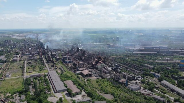 Metallurgical plant ArcelorMittal Kryvyi Rih Ukraine. Iron production. Blast furnace which is environmental pollution. In the summer. Aerial drone. 