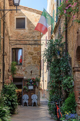 Scenic Alleyway in the Beautiful Town of Pienza, Tuscany, Italy, with an Italian Flag, Wallpaper Background