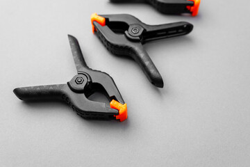 Obraz premium Closeup of black plastic clamps with orange tips