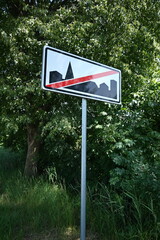 Road sign, end of town.
