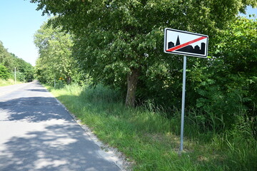 Road sign, end of town.
