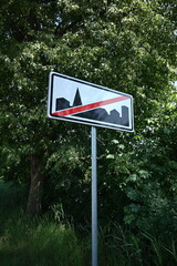 Road sign, end of town.
