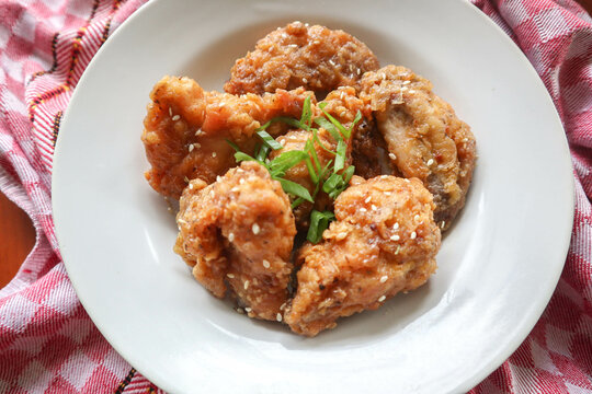 Delicious homemade crispy fried chicken with spicy taste and lemon on plate