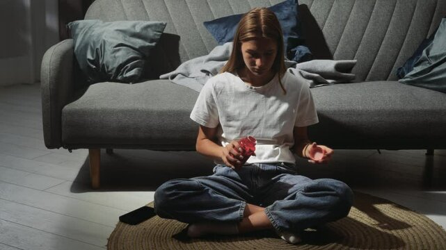 Young Woman Sitting in Front of a Sofa