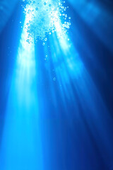 Underwater scene with light beams coming in and bubbles rising to the surface