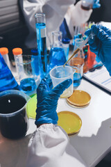 Scientist pipetting medical samples into microplate in laboratory