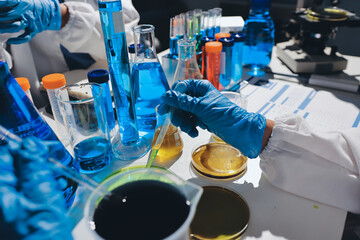Scientist pipetting medical samples into microplate in laboratory