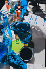 Scientist pipetting medical samples into microplate in laboratory