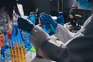 Scientist pipetting medical samples into microplate in laboratory