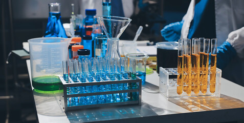 Scientist pipetting medical samples into microplate in laboratory