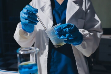 Scientist pipetting medical samples into microplate in laboratory