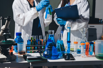 Scientist pipetting medical samples into microplate in laboratory