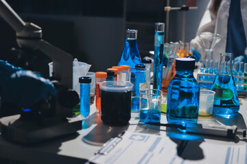 Scientist pipetting medical samples into microplate in laboratory