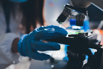 Scientist pipetting medical samples into microplate in laboratory