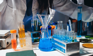 Scientist pipetting medical samples into microplate in laboratory