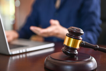 Technology, Information and Cyber ​​Laws Concept.  judge gavel and lawyer using computer in law firm.