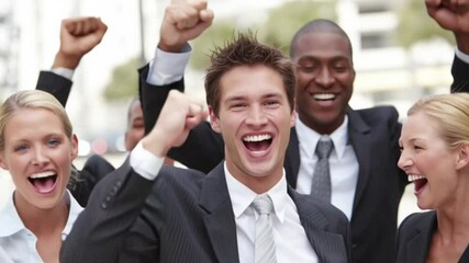 A diverse business team celebrates success with thumbs up - Powered by Adobe