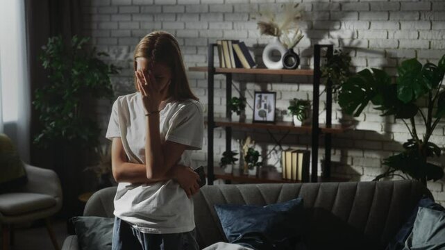 Young Woman in Thoughtful Pose in Cozy Living Room