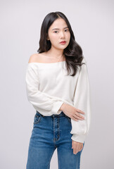Half body portrait happy smile young asian beautiful woman curly hair wearing long sleeve shirt, blue jeans outfit, casual standing pose on white background joy positivity fashion lifestyle concept.