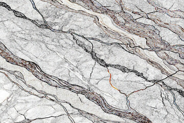 light gray and white marble stone with dark gray veins and a diagonal pattern running throughout the stone texture.