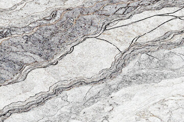 light gray and white marble stone with dark gray veins and a diagonal pattern running throughout the stone texture.