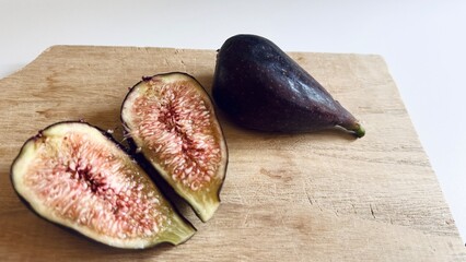 Early fig fruit cut on rustic surface.