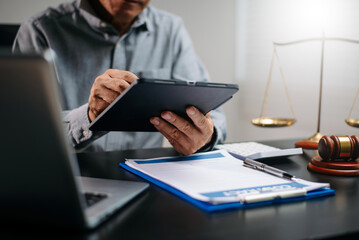 Senior legal advisor using tablet to review digital contract in office. Concept of law, legal tech,...