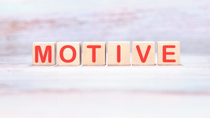 The concept word MOTIVE is assembled from wooden cubes. business motivational concept